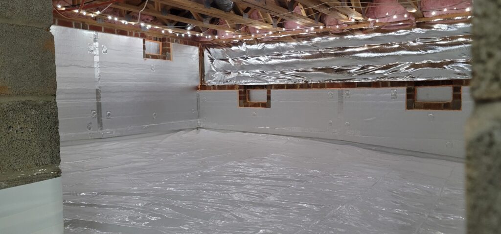 Professional sealed crawl space with white vapor barrier and dehumidifier in a Raleigh, NC home