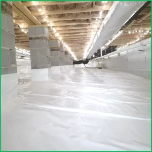 Picture of a clean healthy encapsulated crawlspace very brightly lit with bright white plastic on ground and hardboard insulation on walls and all the wood ceiling is sanitized clean